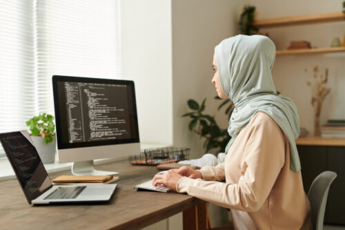 Muslim Woman Working On Computer Code Muslim Woman Working On Computer Code