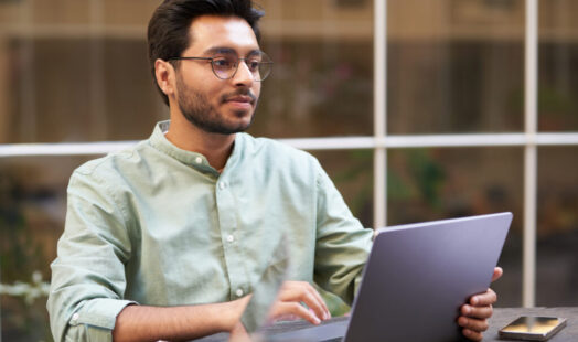 Stylish businessman sitting in modern coworking and working on laptop. High quality photo Stylish businessman sitting in modern coworking and working on laptop. High quality photo