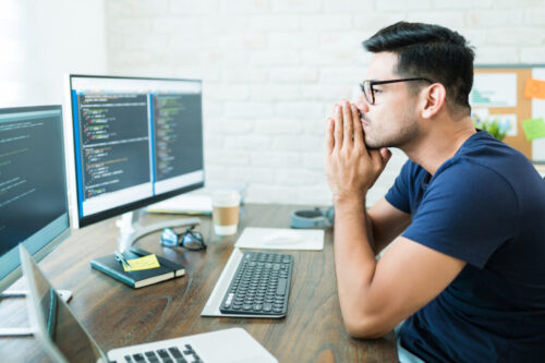 Attractive Latin Computer Science Freelancer Looking At Screens Attractive Latin Computer Science Freelancer Looking At Screens