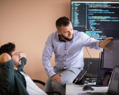 Programmers engrossed in deep collaboration, diligently working together to solve complex problems