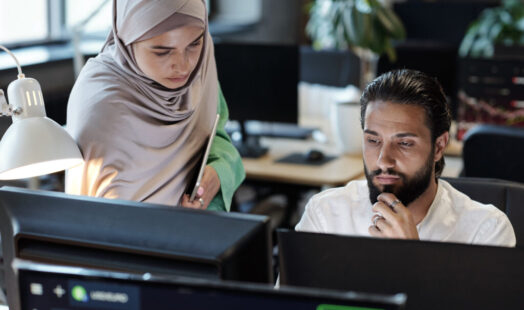 Young Muslim businessman and businesswoman working in front of computer Young Muslim businessman and businesswoman working in front of computer
